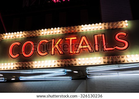 Cocktails Neon Sign and Lights. Cocktails sign in neon and surrounded by flashing lights.