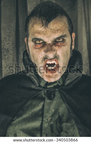 Vampire Dracula. Horror male vampire portrait, edited with vintage film effects.