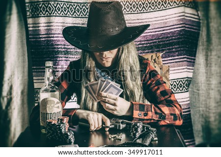 Cowgirl Gunslinger Poker Cards. Old west cowgirl gunslinger sitting at table player poker with peacemaker gun, edited in vintage film style.