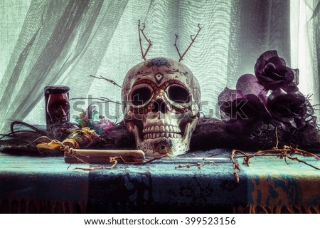 Voodoo Evil Skull Ritual. Voodoo related objects on a table including a skull, a knife and candles.