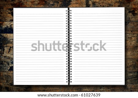 White open notebook on wood background.