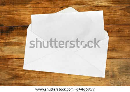 Vintage Envelope with blank paper on wood .