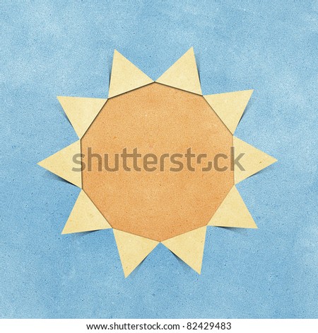 sun hole ripped in recycled paper craft on blue sky paper  background