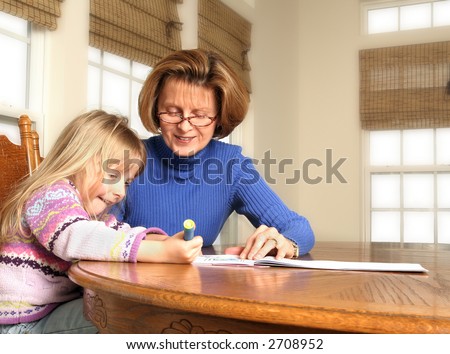Grand-mother and Grand-daughter creating a memory, drawing in a coloring book