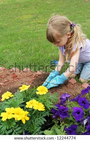 stock photo : Sweet young girl planting flowers in the back yard