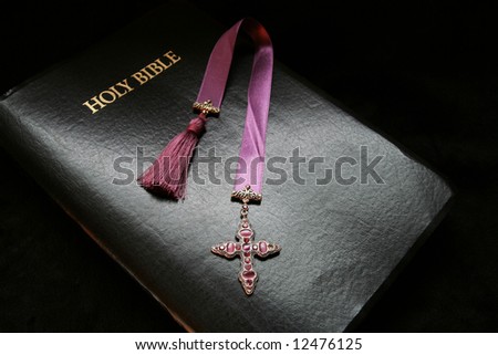Black leather bound bible with Christian cross
