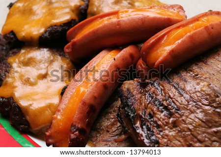 stock photo : Meat platter with hamburgers, hotdogs and steak stuffed with cheddar cheese