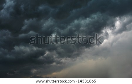 Dark and ominous storm clouds with silver lining