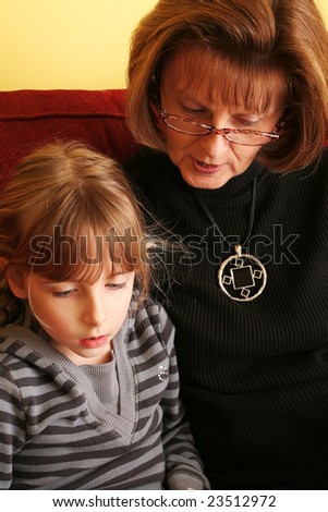 Grand-mother and Grand-daughter creating a memory, reading a book