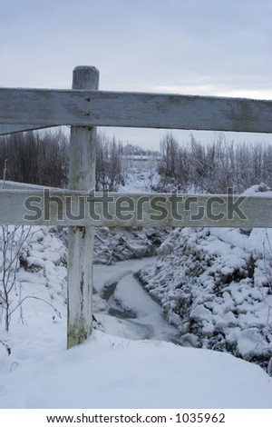 Fence in winter landscape
