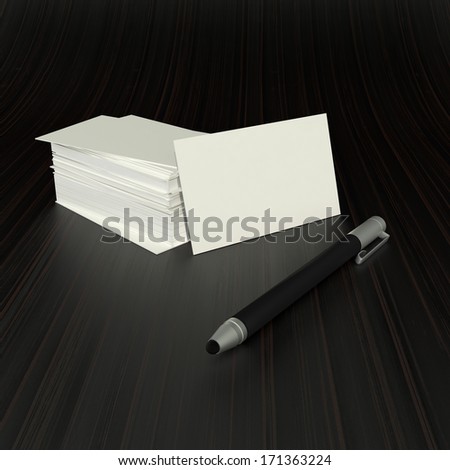 stack of blank visit cards and a modern tablet stylus on dark background