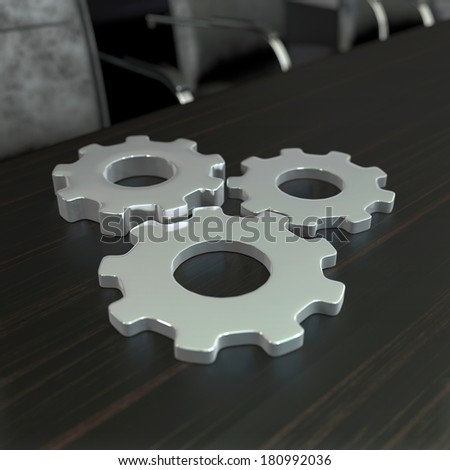 business composition with metal gears on dark wooden tabletop