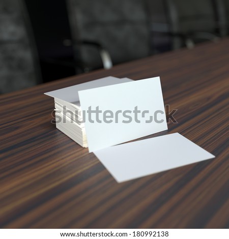 a pile of blank white visit cards on wooden tabletop