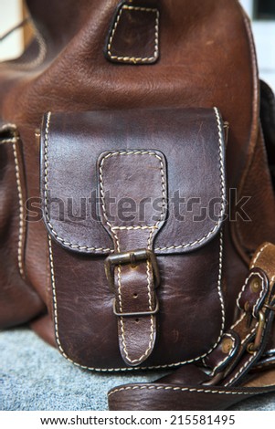 a part of rough brown leather bag with side pocket