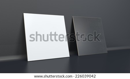 pair of black and white plastic cards standing vertical near black wall