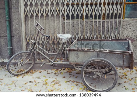 Weathered bike parked on sidewalk in Beijing, China