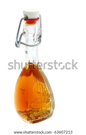 Bottle of alcoholic beverage with honey. Focus on the foreground. Shallow depth of field. Isolated on white background. Studio work.