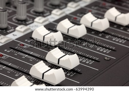 Closeup of audio mixing console. Shallow depth of field. Studio work.