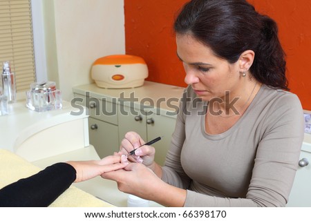 Fingernails manicure. Pro at work with her client.