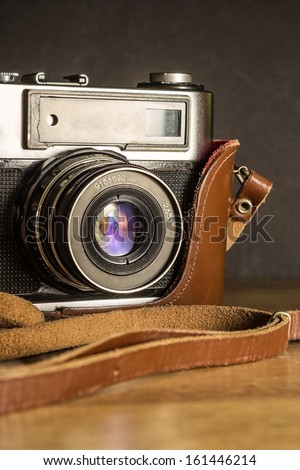 Close up of a vintage film camera with a leather case