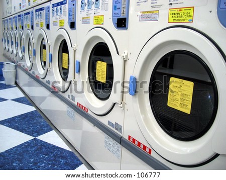 Coin operated drying machines at a laundromat sitting in a row
