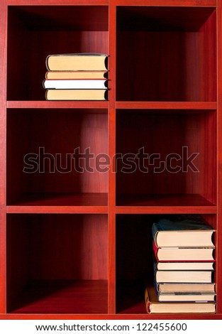 Books and magazines on a brown shelf