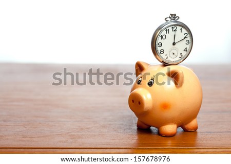 Retro pocket watch on a piggy bank