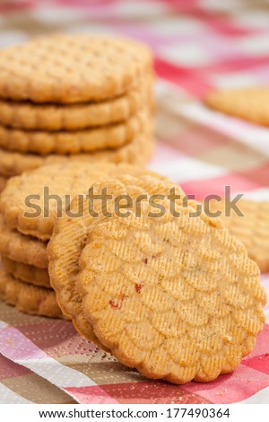 Closeup of round cookies on a striped tablecloth