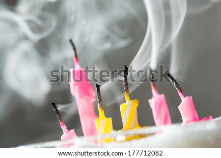 Six blow out candles over grey background. Shallow depth of field, selective focus