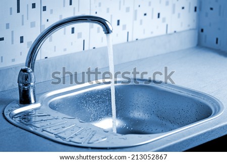 Tap water flowing to a sink
