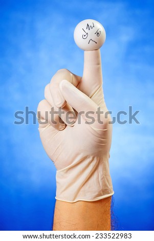Angry face finger puppet over blue background