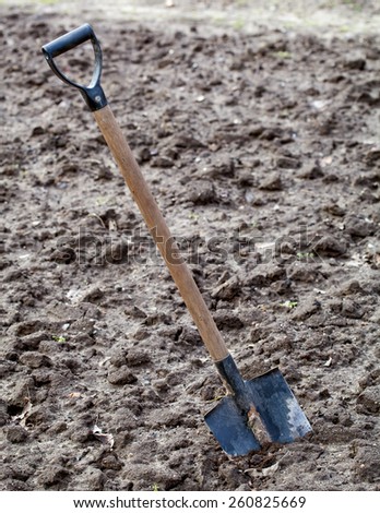 Garden spade stacked in ploughed ground