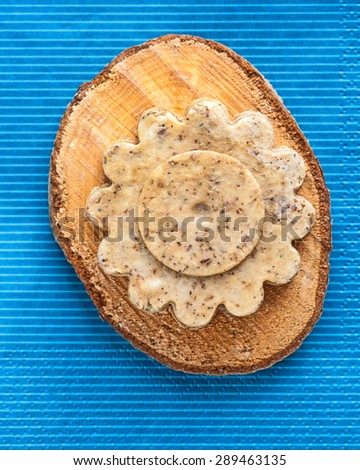 Homemade soap on wooden tray over blue background