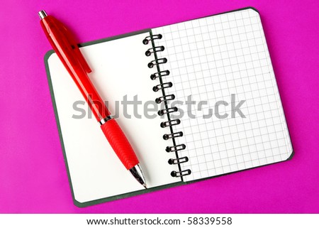 Opened notebook squared page with red pen over it on purple background