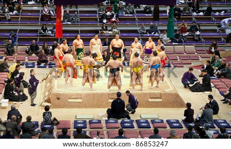 FUKUOKA, JAPAN - NOVEMBER 17: Sumo wrestlers gather around the referee at a Grand Sumo tournament on November 17, 2010 in Fukuoka, Japan. There are six official tournaments held each year in Japan.