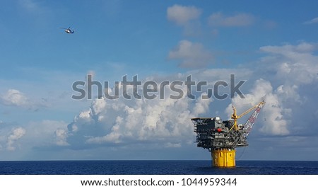 A helicopter leaving a Floating Production and Storage Spar during crew change day in an oilfield situated in Gulf of Mexico.