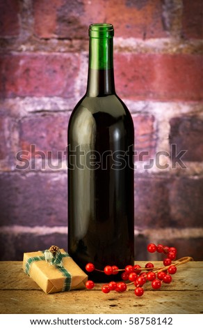 wine bottle with wrapped box and holly