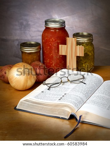 FOOD FOR THOUGHT - canned vegetables and fruit with a bible and pair of glassed on a kitchen counter