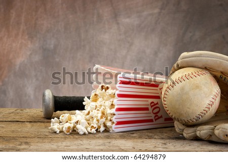 Baseball, bat, mitt, and popcorn on a old vintage set with copy space