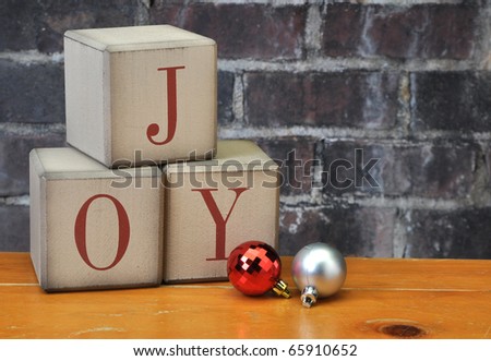 Old vintage holiday blocks spelling the word Joy with and ornaments