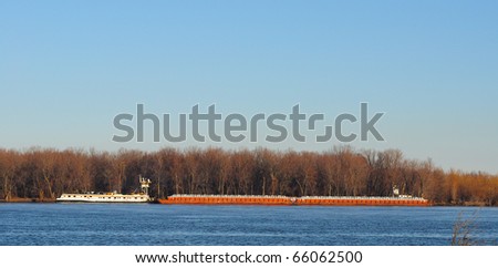 Fall river scene over the Mississippi river Iowa with barge going up river