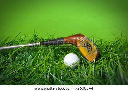 Golf ball and club in the grass on green background with copy space