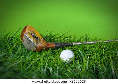 Golf ball and club in the grass on green background with copy space