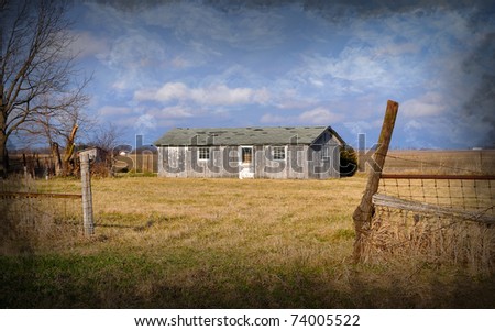 Old vintage chicken Barn with blue sky and clouds and pasture
