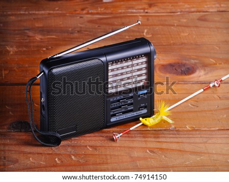 Weather radio with fishing pole on vintage old wood set