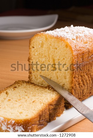 Sugar coated pound cake on a white platter