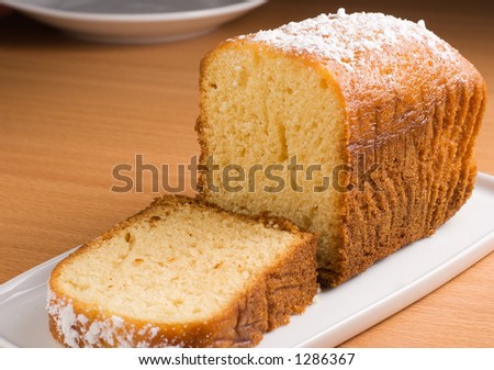 Sugar coated pound cake on a white platter