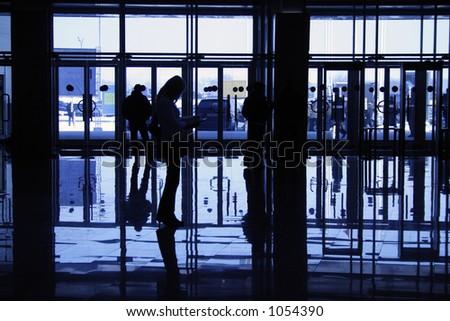 silhouette of woman on background of windows in business-centre