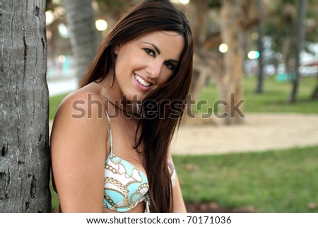 Bikini brunette in the park at Miami beach