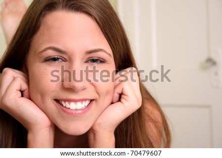 Portrait of young woman with hands on face